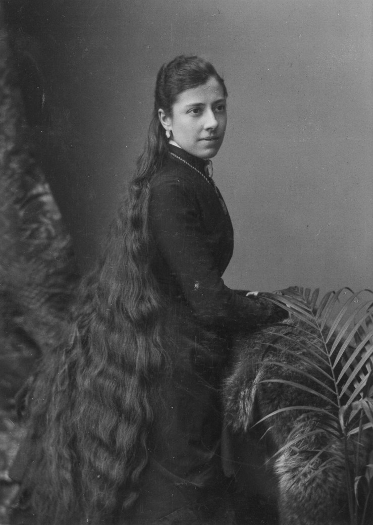 Portrait of a young woman with very long hair, circa 1900s. (Photo by: PYMCA/UIG via Getty Images)